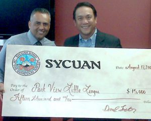 Park View Salvador Rivera (left) of Sycuan presents a check to Rod Roberto, Park View Little League President.