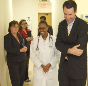 Dr. Bahghi Keflezighi gives a tour of the Diamond Neighborhood Family Health Center to Assemblymember Hector de la Torre.