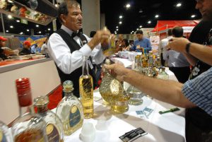 A bartender serves samples of tequila at the Expo Comida Latina trade show exhibit at the San Diego Convention Center. Photo - David Maung