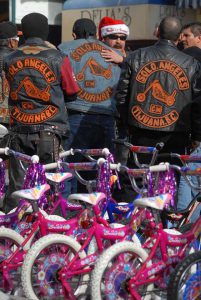 motorcycles 03 An unidentified motorcycle rider with a Santa hat greets members of the motorcycle club Solo Angeles during the Tijuana Toy Run.