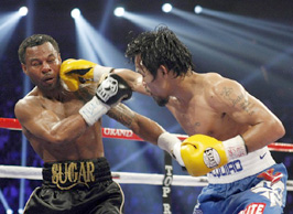 Mosley of the U.S. takes a punch from Pacquiao of the Philippines during their WBO welterweight title fight at the MGM Grand Garden Arena