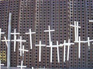 Wooden crosses on the border wall.