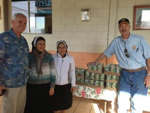 Bob Fletcher, Ken Franke at Orphanage, with donated cans of tuna.