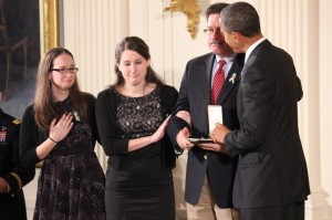 Bill Sherlach, accompanied by his daughters, Maura Schwartz, left, and Katy Sherlach, accepts the Citizens Medal of Honor from President Barack Obama on behalf of his wife, Mary Sherlach, one of the adult victims of the Sandy Hook Elementary School shooting in December. SHFWire photo by Jasmine Aguilera