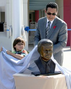 Enrique E. Camarena, with son, unveils bust of his father, whose name now graces the Chula Vista Elementary School District’s newest school.
