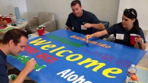 ARAMARK volunteers hard at work on the welcome sign in several languages.
