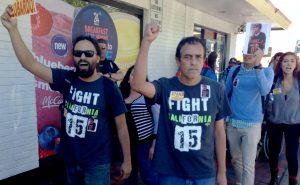 Community activist Tony Perez (left) and laid-off McDonald’s employee Leobardo Meza (right) during the protest to demand Meza be given his job back.