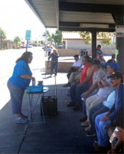 Promotora Elizabeth Valdez gives an info session on sexual health at a bus stop in Calexico. Photo by Amy Denhart. 