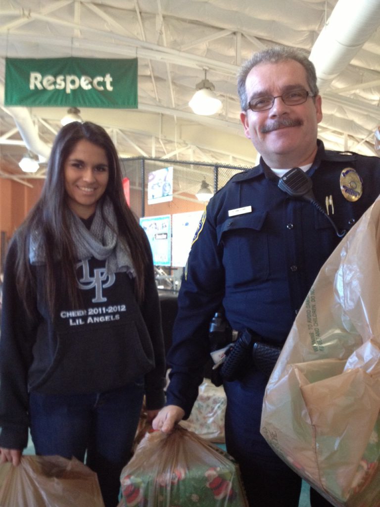 Officer Hinkledire and his daughter delivering gifts in Chula Vista.