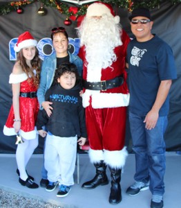 Xavier the X-Man (right) pictured with Santa a young lady and her, and Santa’s helper Yasmine Franco at the yearly event on held on Saturday Dec. 14th. 