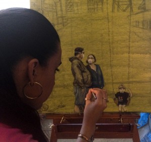 Artist Stephanie Cecilia Cervantes paints her piece for the Barrio Logan exhibition, Until Our Last Breath, where artivists say no to the contamination of the Logan Heights area. Photo Credit: Valerie Johnson/Multimedia Diva. 