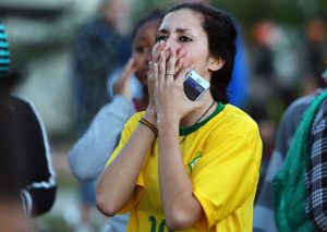Brazilina fans react during the public viewing of the 2014 FIFA World Cup Brazil vs Germany semifinal football match, in Porto Alegre on July 8, 2014. AFP PHOTO/Lucas UEBEL