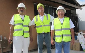 WORKER CENTER: Day laborers Nelson Gamio (center) with Jorge Ruiz (left) and Raul Magana (right) outside the future home of the San Diego Worker Center in Barrio Logan.