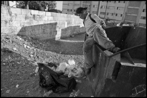 TIJUANA, BAJA CALIFORNIA NORTE, MEXICO - 9SEPTEMBER14 - Luisa, a homeless woman, collects cans and plastic from garbage dumpsters, near the Tijuana River, in downtown Tijuana, not far from the U.S. Mexico border. Copyright David Bacon
