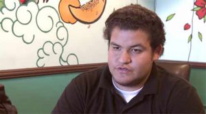 Jason Magaña, a student at L.A.’s Jefferson High School, said he was enrolled this fall in a graphic design course he’s already taken and passed twice. An aspiring aeronautical engineer, he’s part of a suit filed by students at various schools who say they have been put into “work” periods or “home” periods with no instruction rather than academic classes that are unavailable or too crowded. Screenshot/ Youtube (courtesy of Center for Public Integrity).