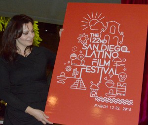 Pilar Kuri, Festival Planner for the Latino Film Festival, presents the winning poster by Zoran Cardula of Macedonia 