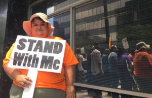 Karen Maier protesting outside Toni Atkin’s office June 17