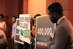 Students Duncan Robinson, left, of University of Maryland-Baltimore County, Julia Burzynski of Washington University and Josh Odam of University of Massachusetts-Amherst promote debt free college at the Capitol. Democratic lawmakers say they want Hillary Clinton to join other Democratic presidential candidates to endorse the idea. SHFWire photo by Quentin Misiag