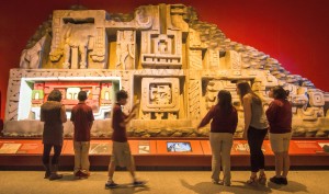 Visitors with Xunantunich Frieze Replica: Maya builders reflected their worldview in their colorful and imposing cities. Visitors to Maya: Hidden Worlds Revealed will see this huge re-creation of a section of a famous frieze from the El Castillo pyramid in Xunantunich, a Maya civic ceremonial center.