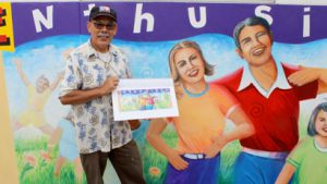 Sal Barajas and the partially completed mural at Lincoln Acres Library
