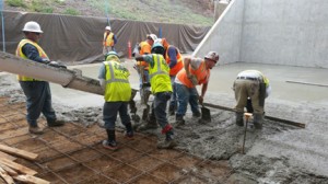 Urban Corps members pouring cement for the handball court.