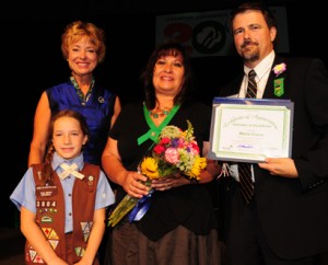 Girl Scout Brownie Sophia DeMille, Troop 3884, Girl Scouts San Diego CEO Jo Dee Jacob and board chair Rick Brooks congratulate Maria Casas on garnering the Volunteer of Excellence award.